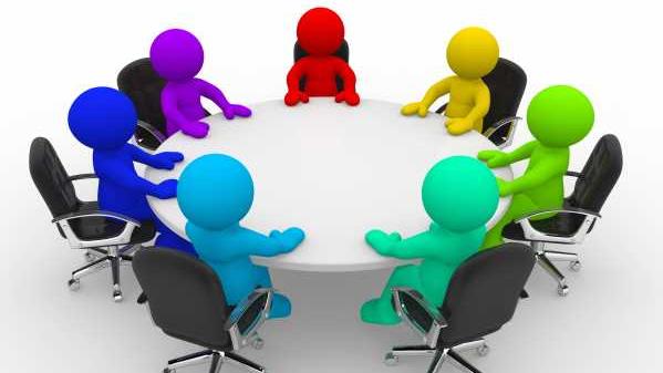 Een tekening van een vergadertafel met gekleurde poppetjes 